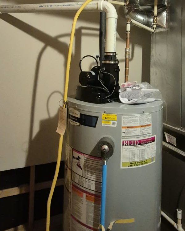 Power-vent water heater with blower and PVC vent